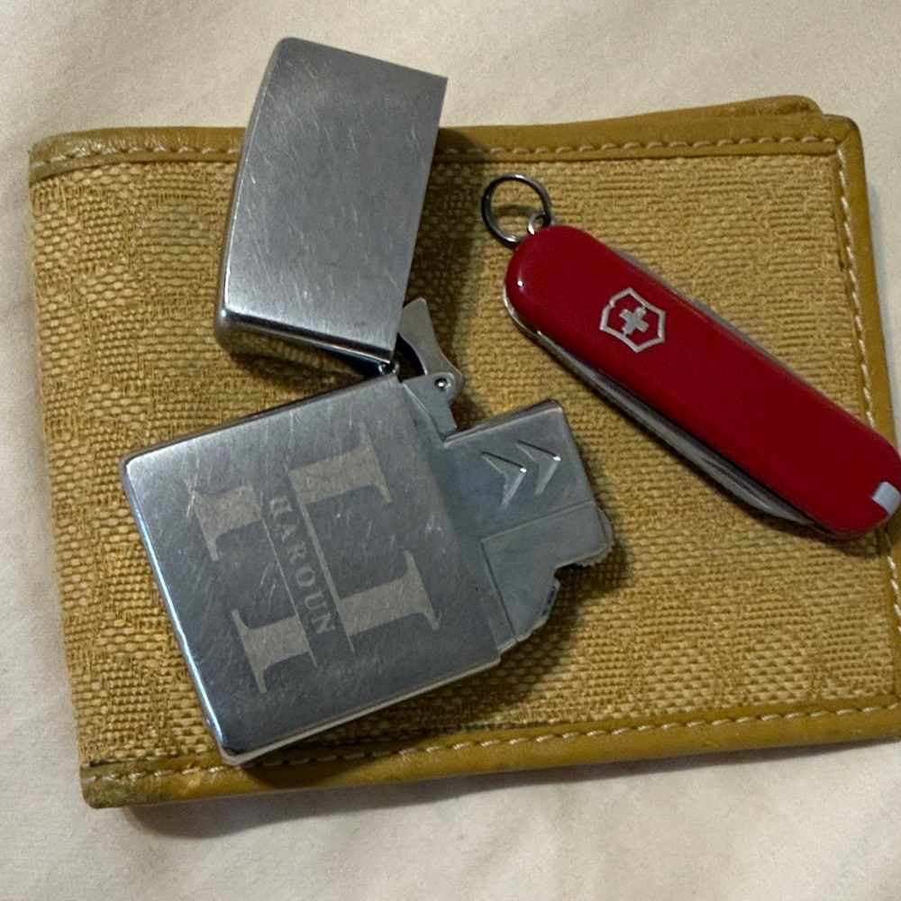Coach, Swiss army , zippo .Tan Wallet with Silver Lighter and Red Pocket Knife